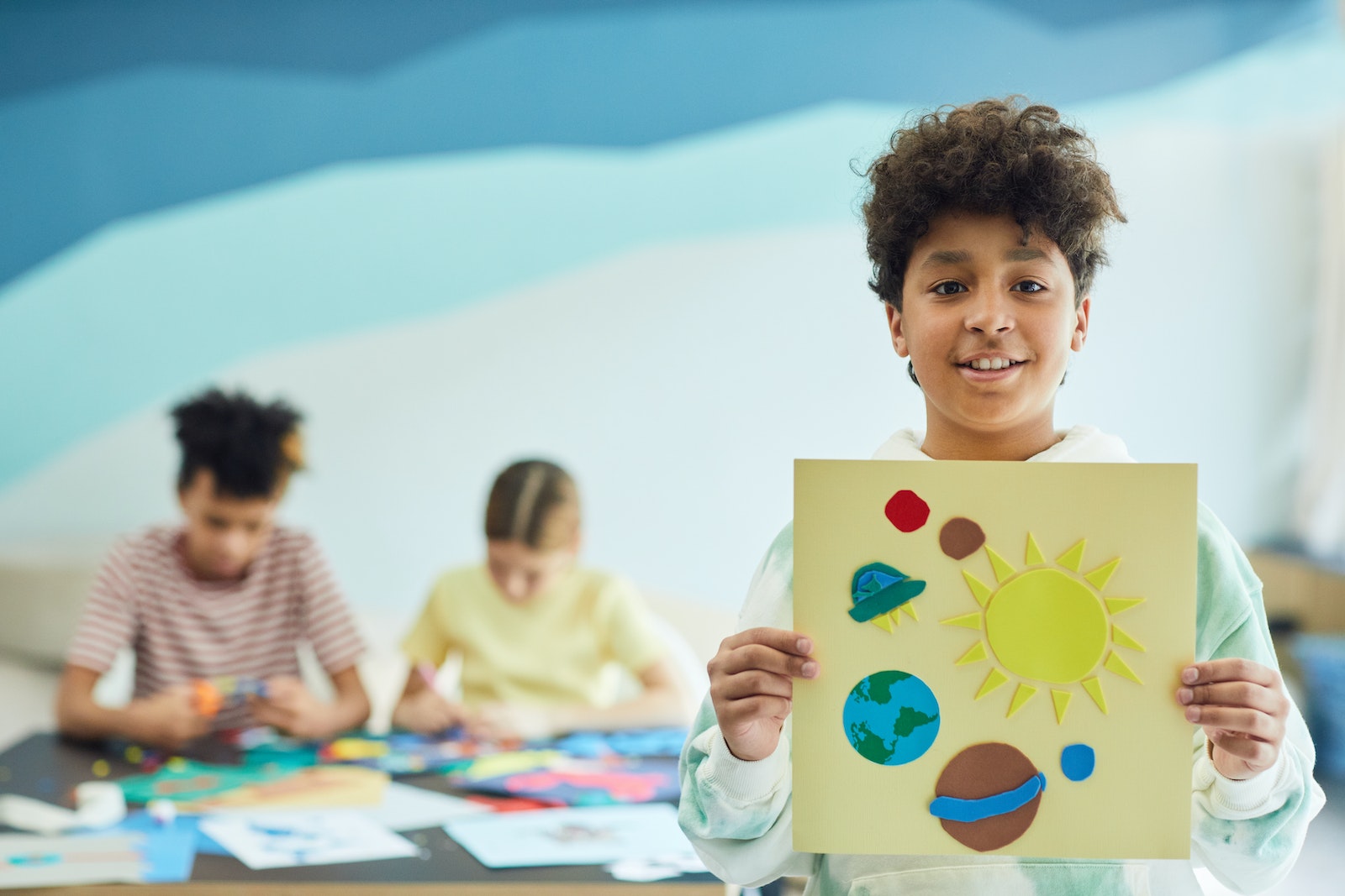 A Boy Holding his Art Project